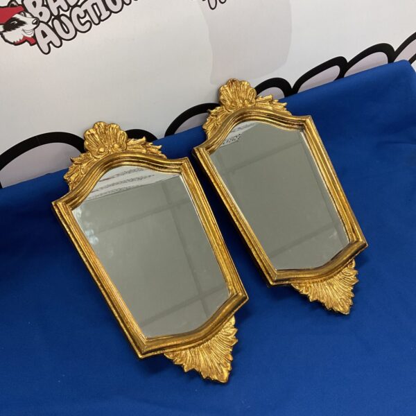 Pair of ornate gilt framed Italian mirrors for wall decor.