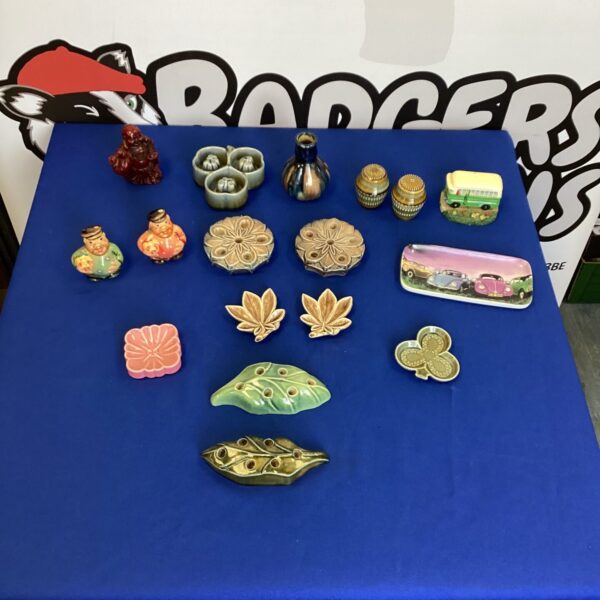 Vintage novelty pottery collection with salt and pepper pots.