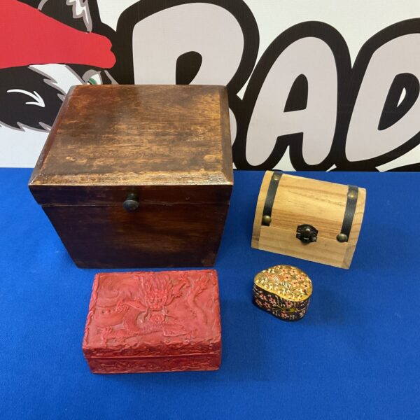 Intricately carved Chinese dragon on a wooden trinket box.