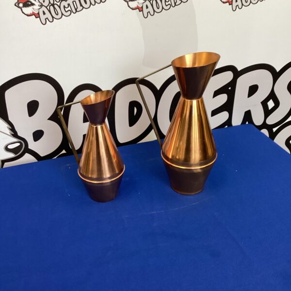 Pair of vintage copper jugs for collectors and home decor.
