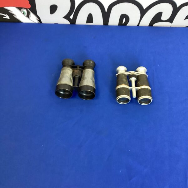 Pair of vintage binoculars on a blue background.
