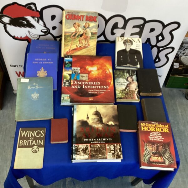 Vintage book lot with colourful covers and aged pages.
