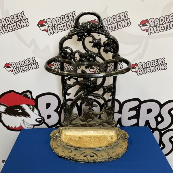 Intricate Victorian cast iron umbrella stand for hall decor.