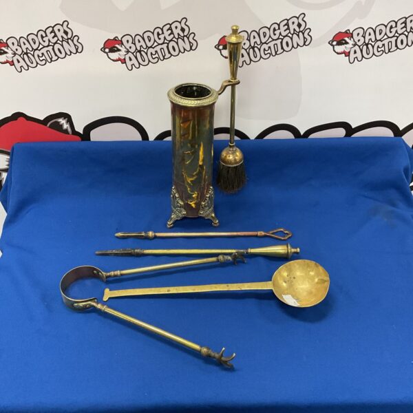 Vintage brass fireplace companion set with ornate detailing.