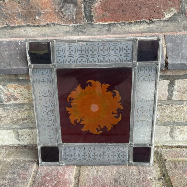 Vintage leaded stained glass sunflower panel with warm tones.