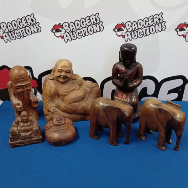 Collection of carved wooden Buddhas and elephants for collectors.