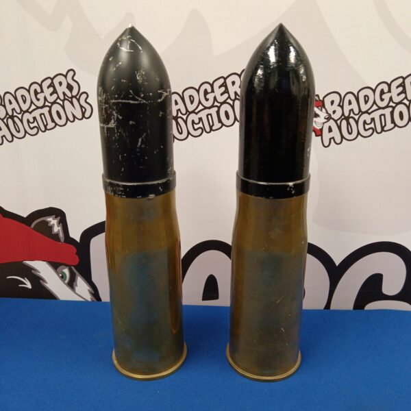 Pair of vintage 76mm cannon shells from 1973, military collectibles.