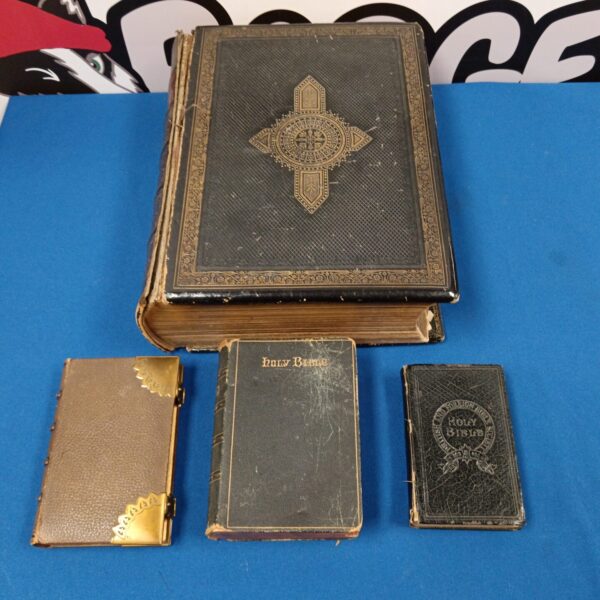 Lot of four antique bibles with embossed covers.