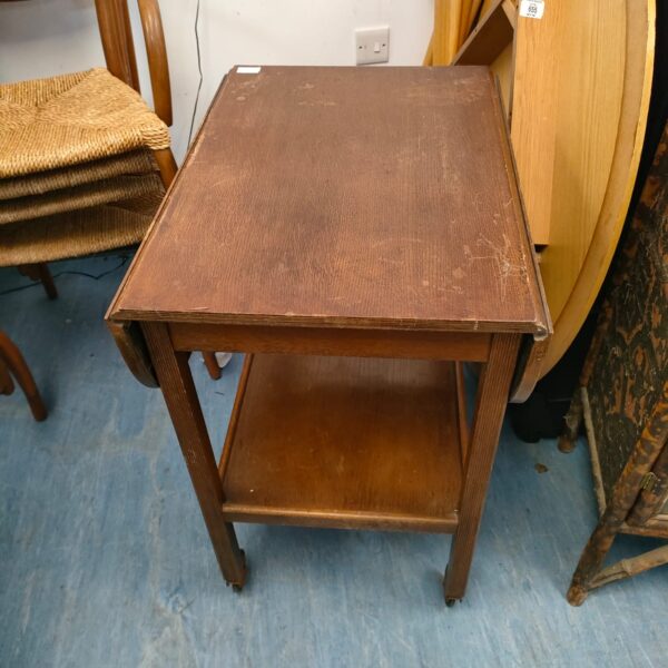 Vintage mahogany drop leaf trolley with folding leaves.