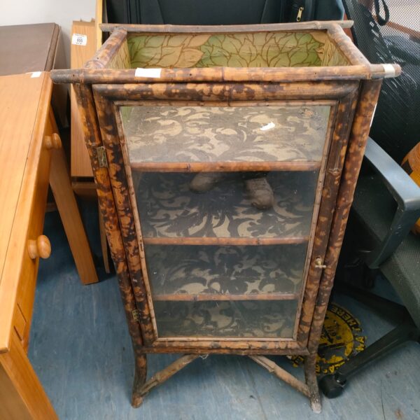 Antique tiger bamboo display cabinet with glass front.