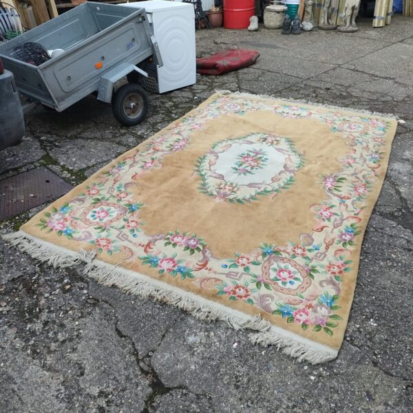 Large cream floral rug with patterned design.