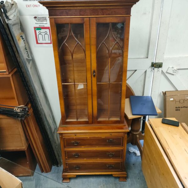 Antique walnut display cabinet with glass front and Victorian details.