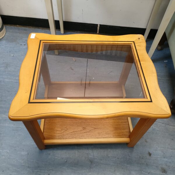 Vintage glass top coffee table with wooden frame and shelf.