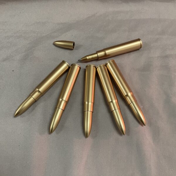 Six vintage 303 bullets pens displayed on a neutral surface.