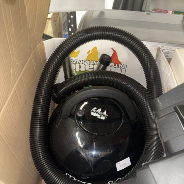 Red Numatic Henry Hoover in original box, vintage cleaning appliance.