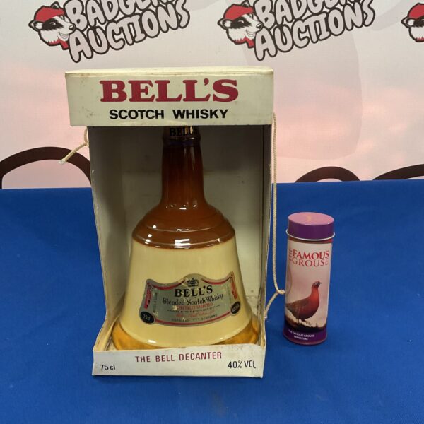 Sealed vintage Bells Scotch Whiskey decanter and Famous Grouse miniature.