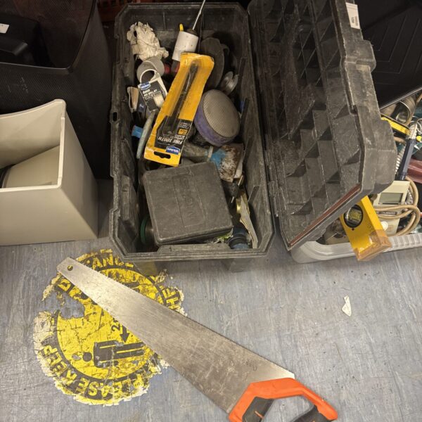 Vintage plastic toolbox with hand saw and assorted tools inside.