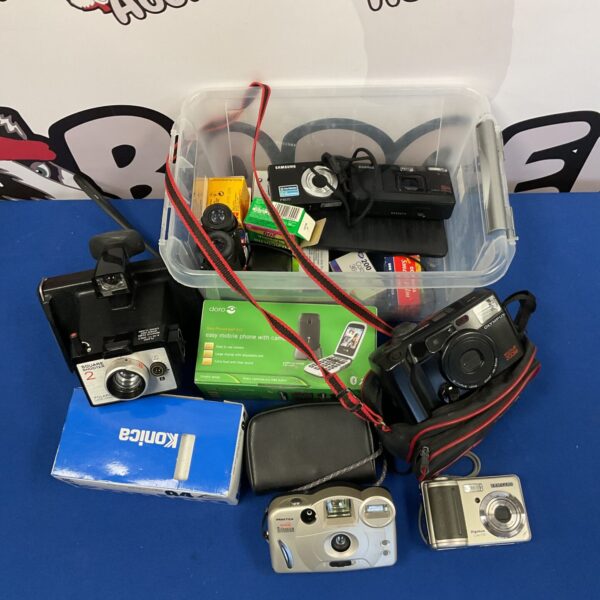Vintage camera collection lot with various film cameras.