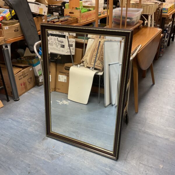 Antique mahogany mirror with bevelled edge for vintage home decor.