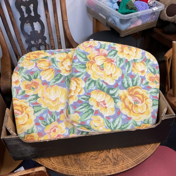 Set of eight yellow rose seat cushions for dining chairs.