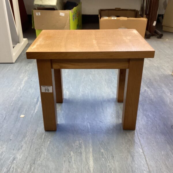 Small solid oak table with a warm wood tone.
