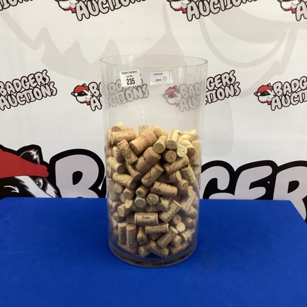 Clear glass jar filled with a large wine cork collection.