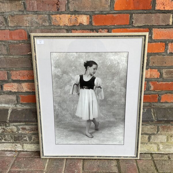 Vintage black and white photograph of a ballet dancer in a frame.