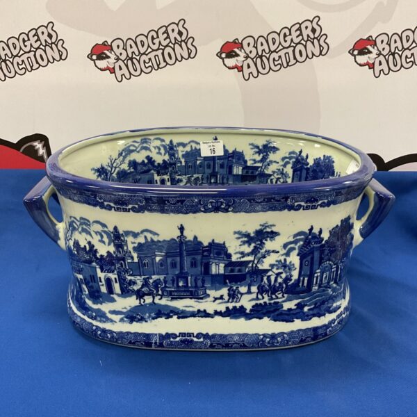 Antique Victorian porcelain foot bath with blue and white landscape design.