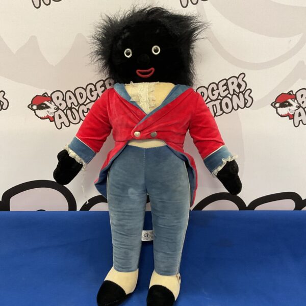 Vintage Merrythought Golly doll with red jacket and black hair.