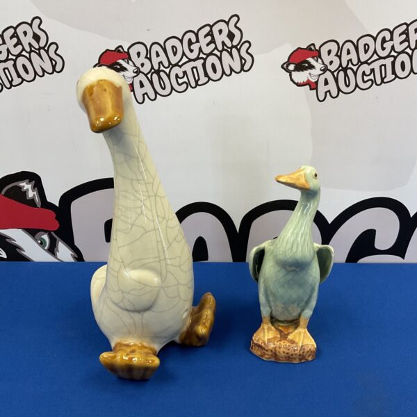 Vintage pottery duck ornaments, a charming collectible pair.