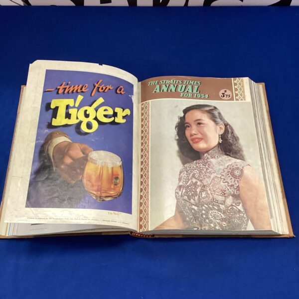 Open Straits Times Annual 1954 showing colourful cover and interior pages.