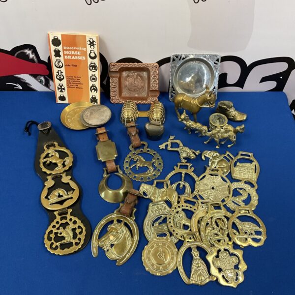 Vintage horse brasses and book on equestrian collectables.