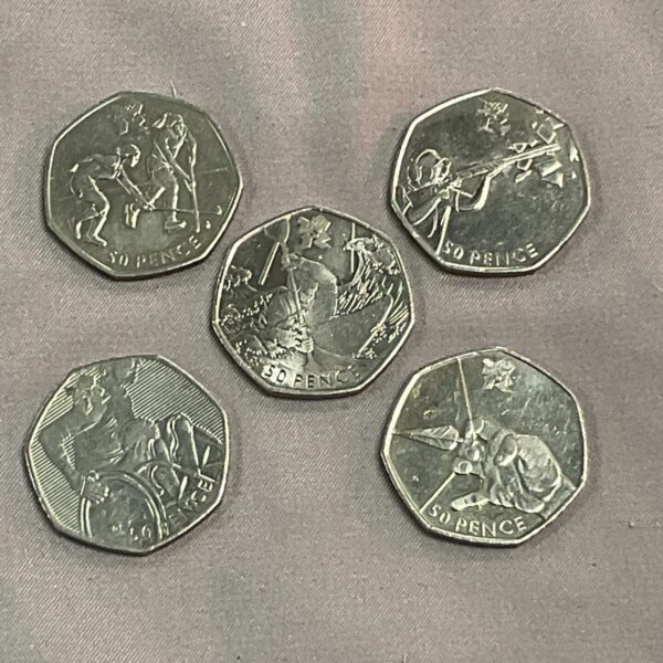 Close-up of a 50p coin collection featuring commemorative designs.