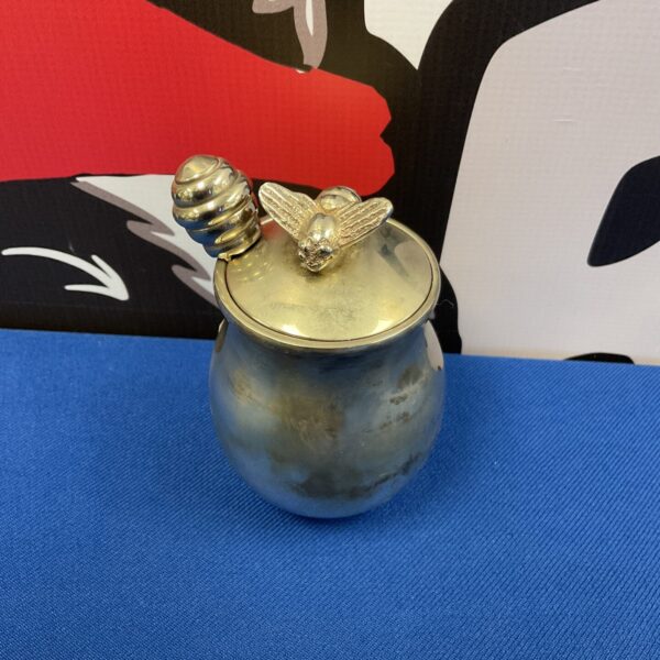 Vintage silver plate honey pot with a bee finial.