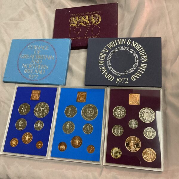 Great Britain proof coin sets from 1970, 1972, and 1977.