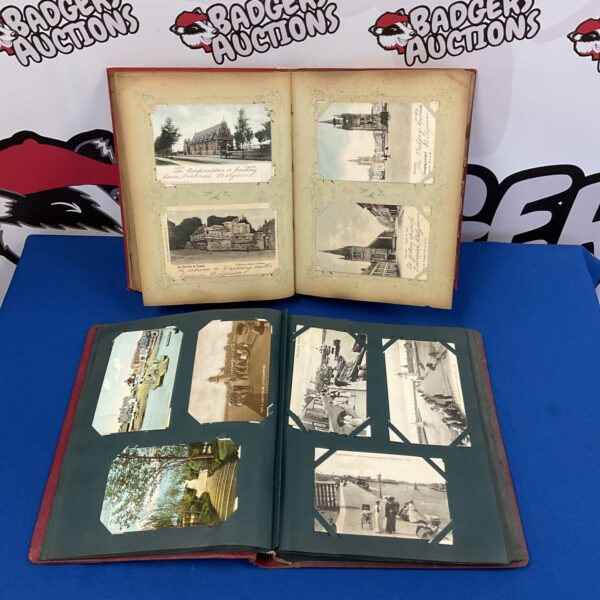 Open antique postcard album displaying vintage postcards and scenes.
