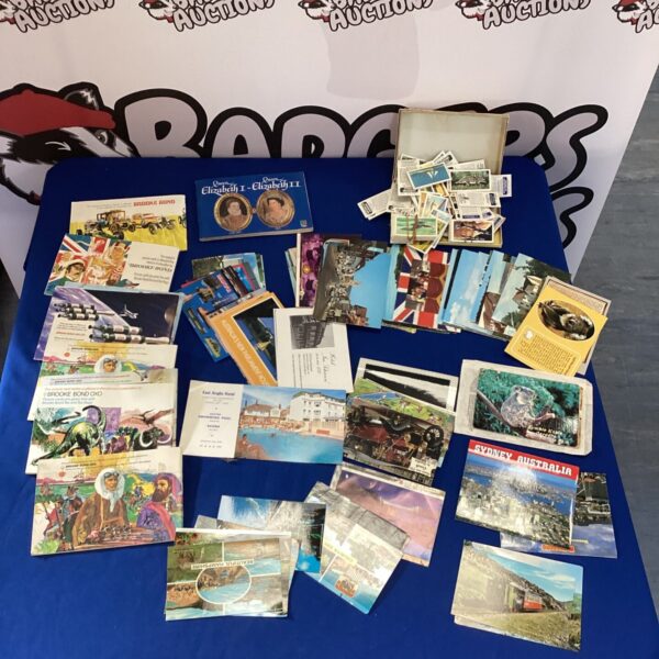 Vintage postcard and cigarette card collection with albums for collectors.