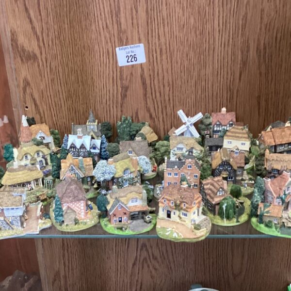 Detailed Danbury Mint house figures in a village collection.
