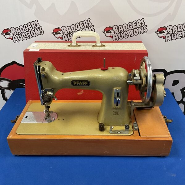 Vintage Pfaff sewing machine in original case, collectible item.