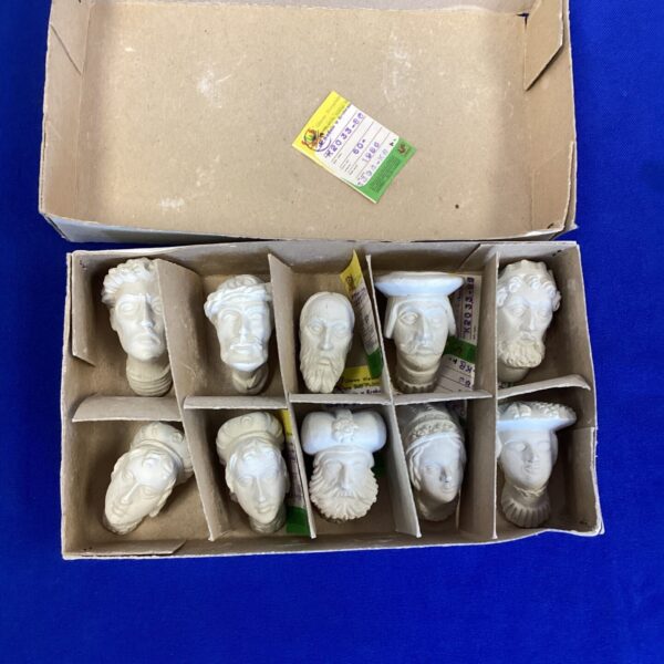 Vintage plaster busts in original cardboard box, collectible miniature sculptures.