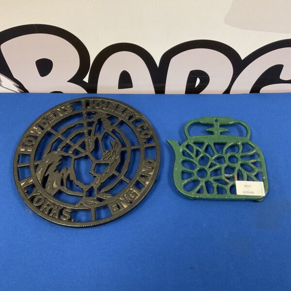 Vintage Howdens Joinery cast iron trivet with floral design.