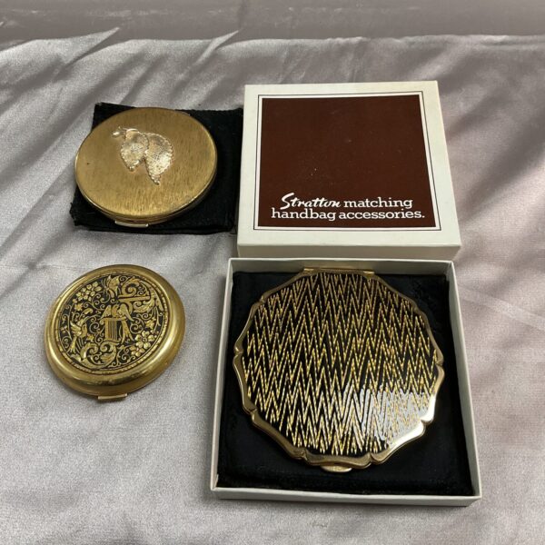 Vintage gold Stratton compact mirror for makeup and powder.