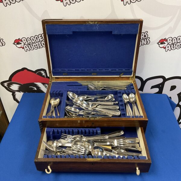 Vintage Guy Degrenne silver plate cutlery set displayed in an oak case.
