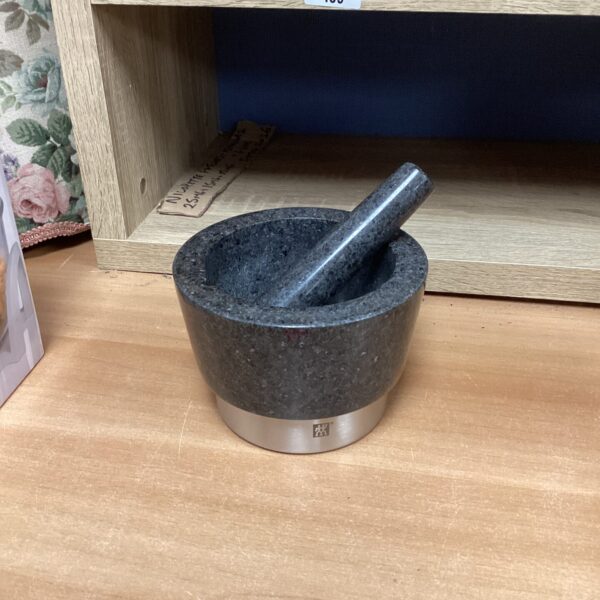 Solid granite pestle and mortar for grinding spices.