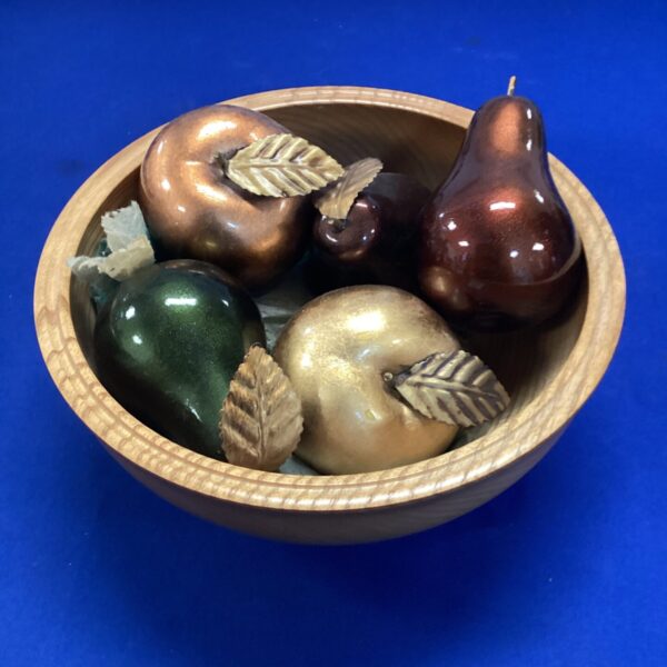 Decorative wooden bowl with metal fruit centrepiece.