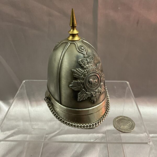 Vintage cavalry helmet lighter with detailed crest.
