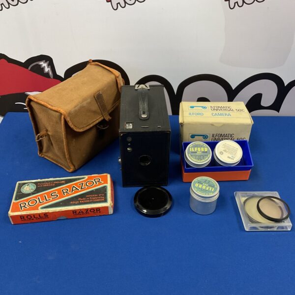 Vintage Kodak Brownie box camera with razor in box.