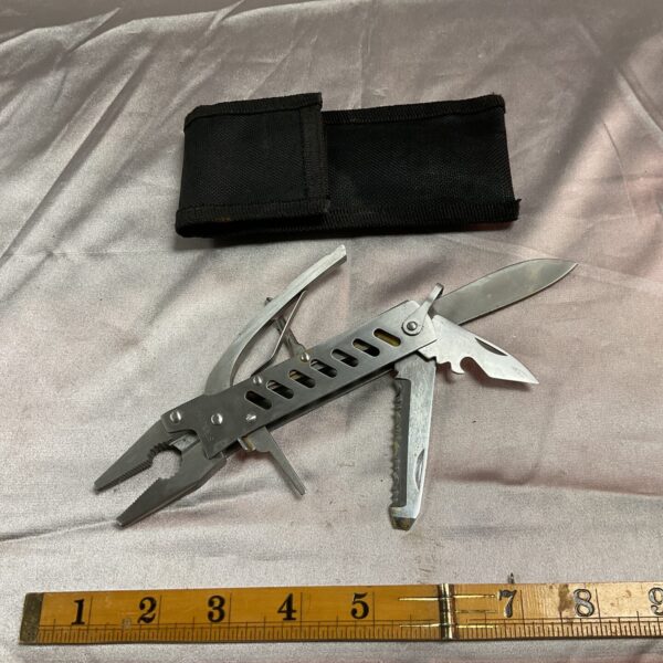 Stainless steel multi tool with nylon sheath for outdoor use.