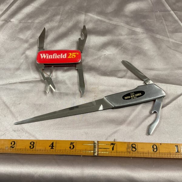 Vintage Winfield 25 pocket knife and ICI letter opener, collectible desk accessories.