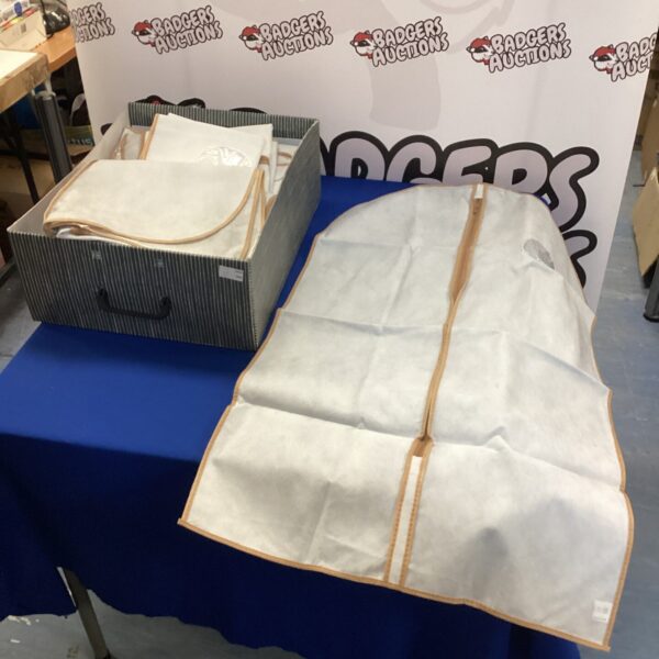 Lot of used suit carry bags for clothing protection.